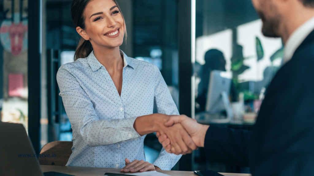 Smiling businesswoman closing a business deal with a handshake.